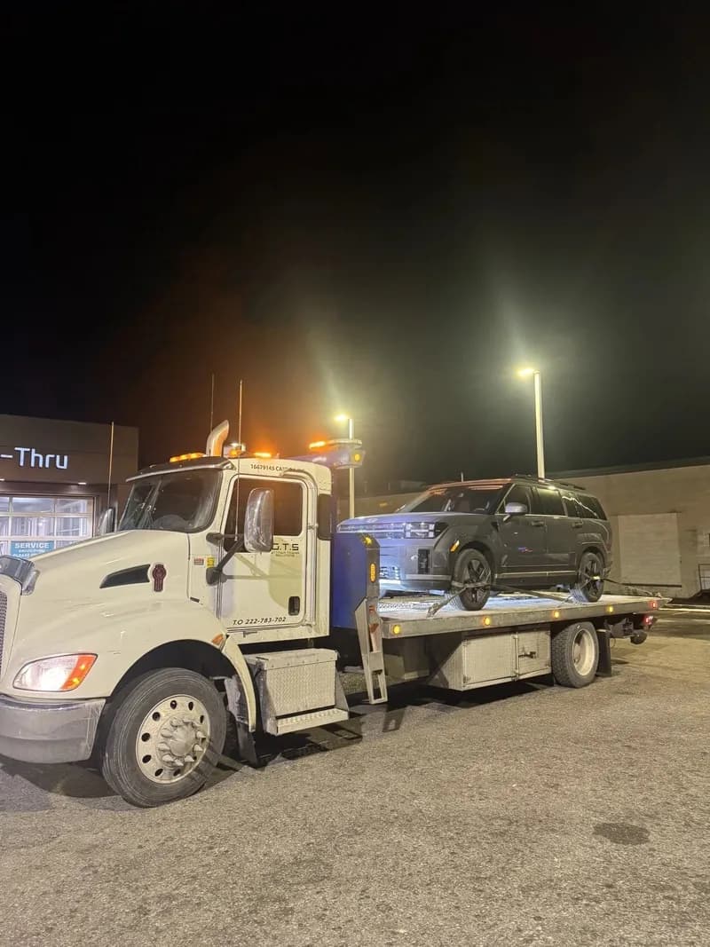 Flatbed tow truck loading a vehicle in Ottawa