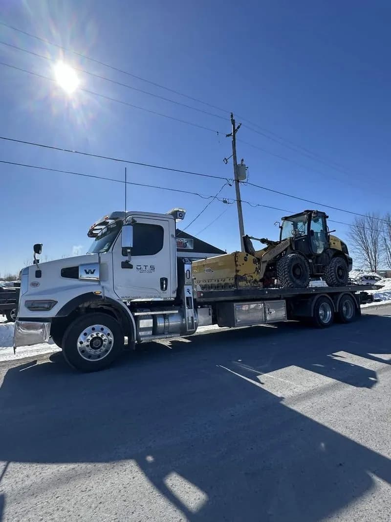 Ottawa Towing Solutions flatbed transporting heavy equipment
