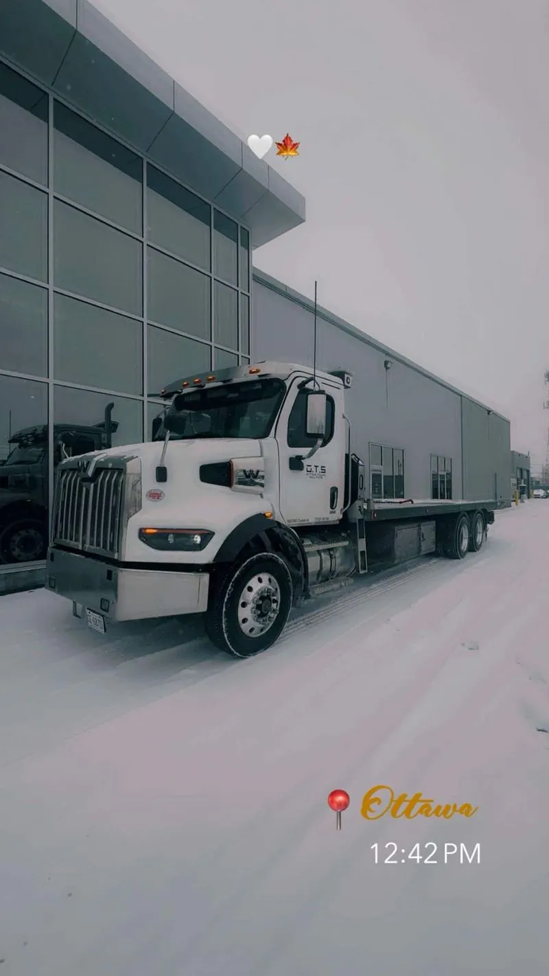 OTS flatbed truck in the snow outside a warehouse in Ottawa